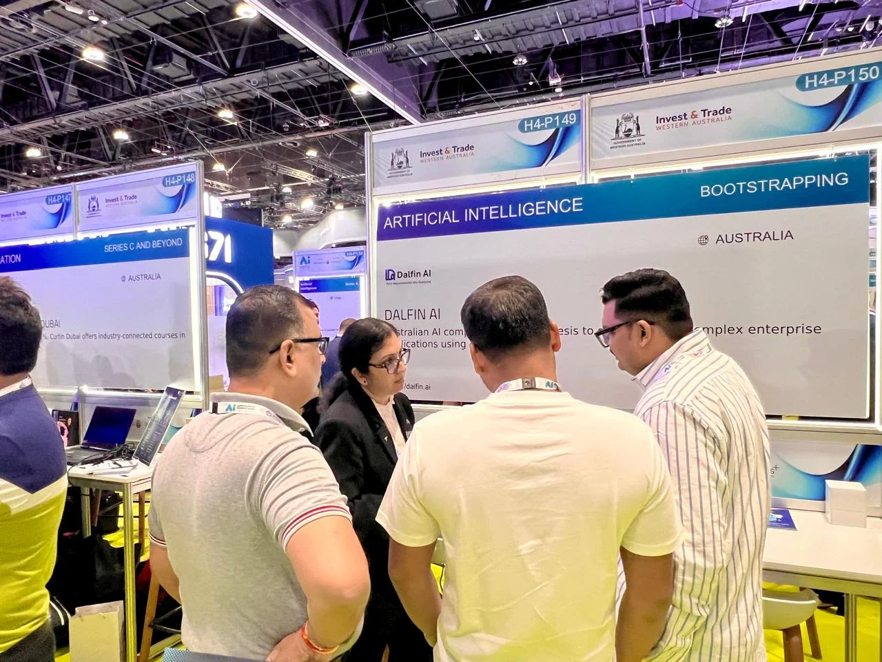 Visitors in discussion at the Dalfin AI exhibition space.