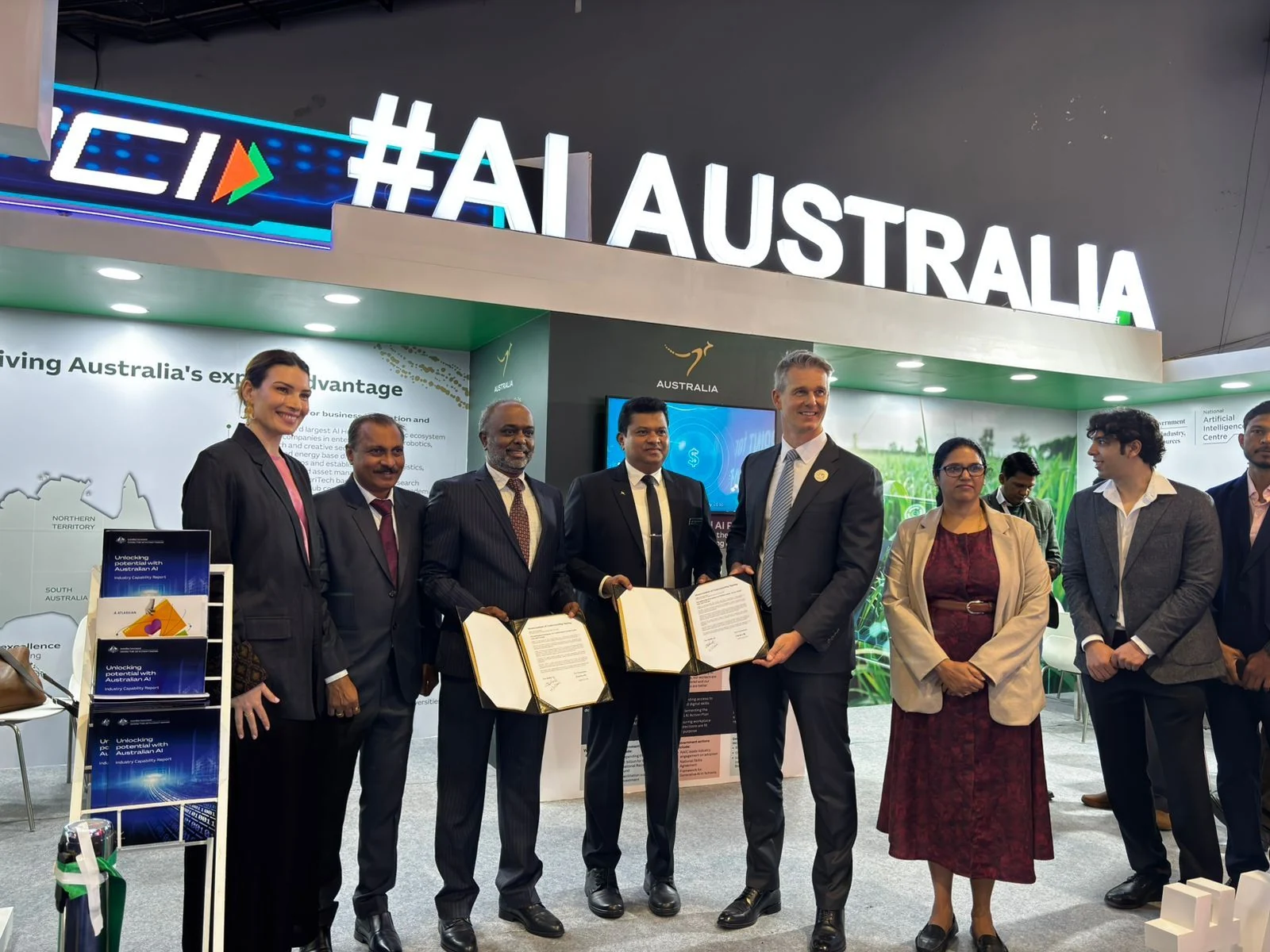 Dalfin AI and Grassroots signing an MoU at the Australian Pavilion.